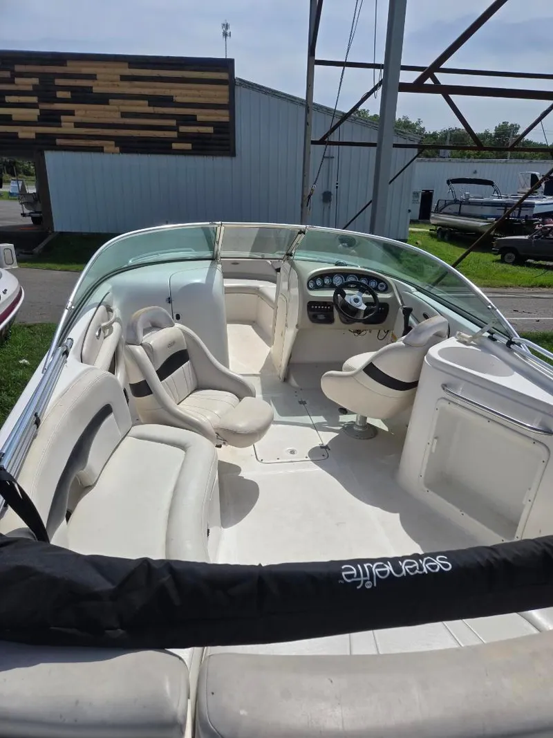 Slide: The Image of 2001 Chaparral 230 SSi boat interior with white seating and steering console. - 4