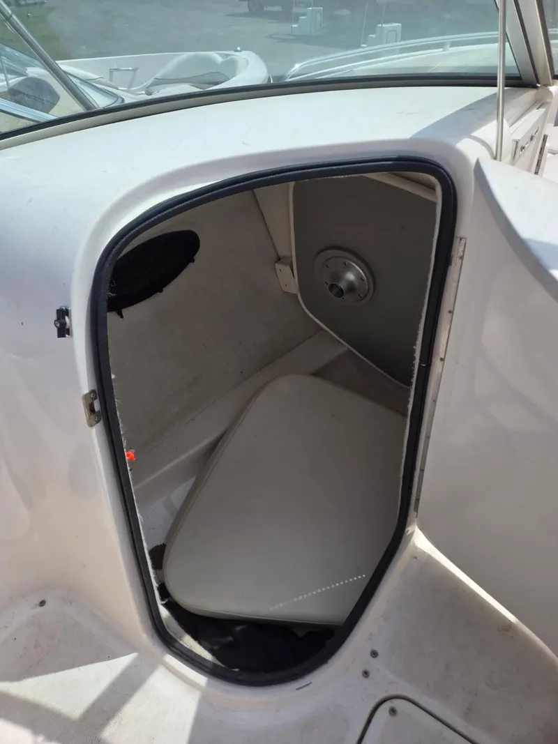 Slide: The Image of 2001 Chaparral 230 SSi boat interior storage compartment with open door. - 7