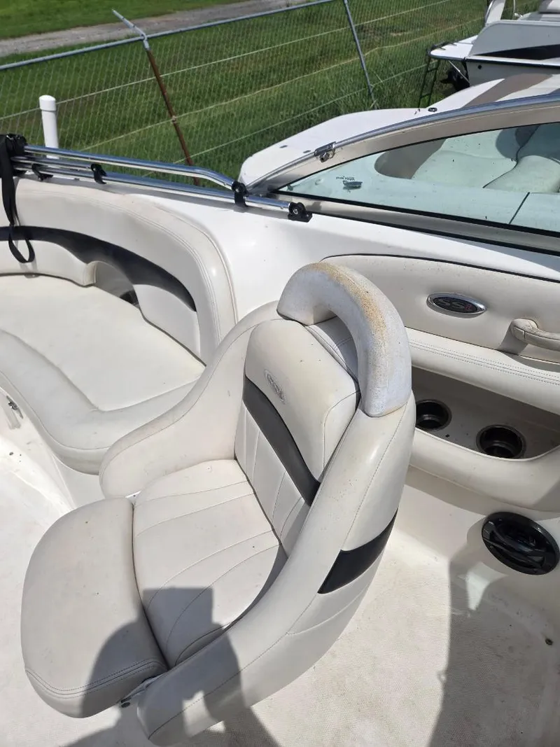 Slide: The Image of 2001 Chaparral 230 SSi boat interior with white seating and dashboard details. - 9