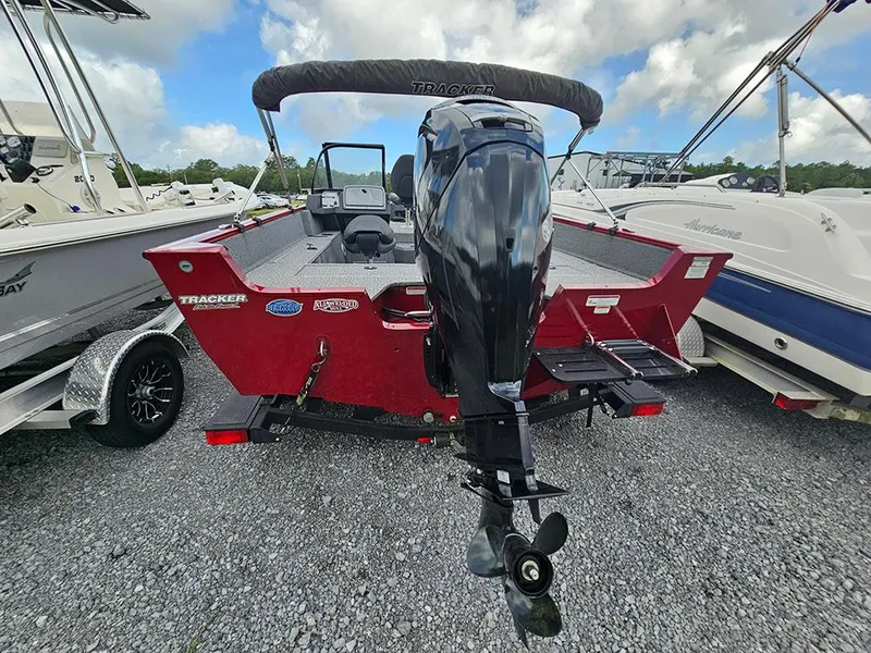 Slide: The Image of 2022 Tracker Pro Guide V-175 WT boat with outboard motor, parked on gravel. - 4
