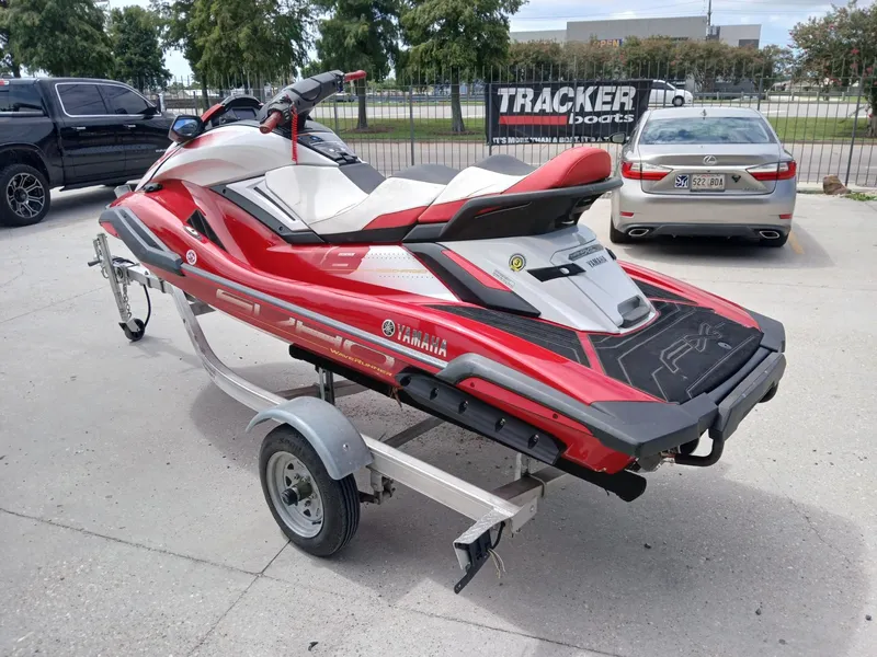 Slide: The Image of 2021 Yamaha WaveRunner FX SVHO in red on a trailer, parked outdoors. - 3