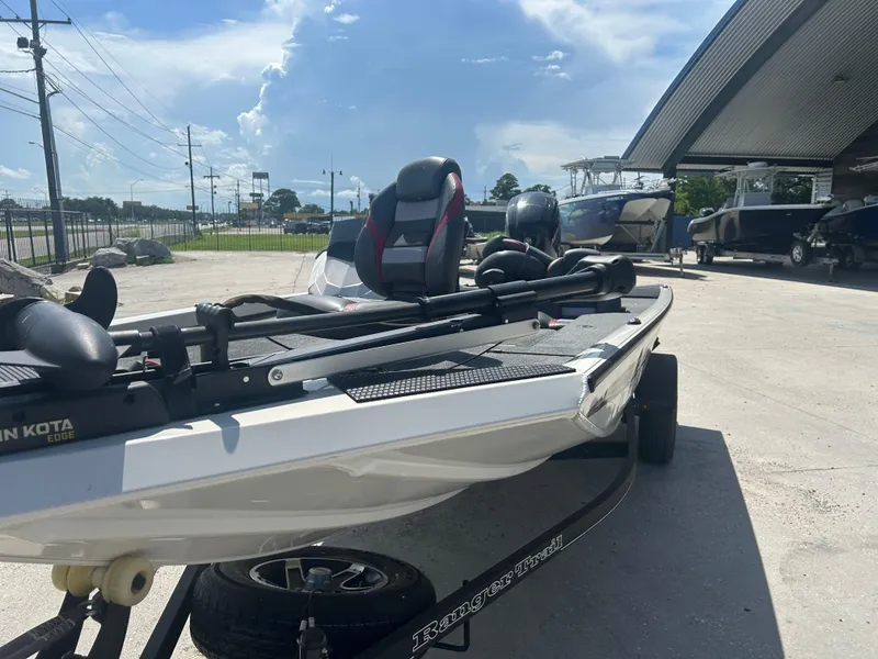 Slide: The Image of 2021 Ranger RT178C boat on trailer, parked outdoors under a sunny sky. - 5