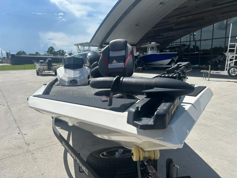 Slide: The Image of 2021 Ranger RT178C boat on trailer, parked outdoors near a modern building. - 7