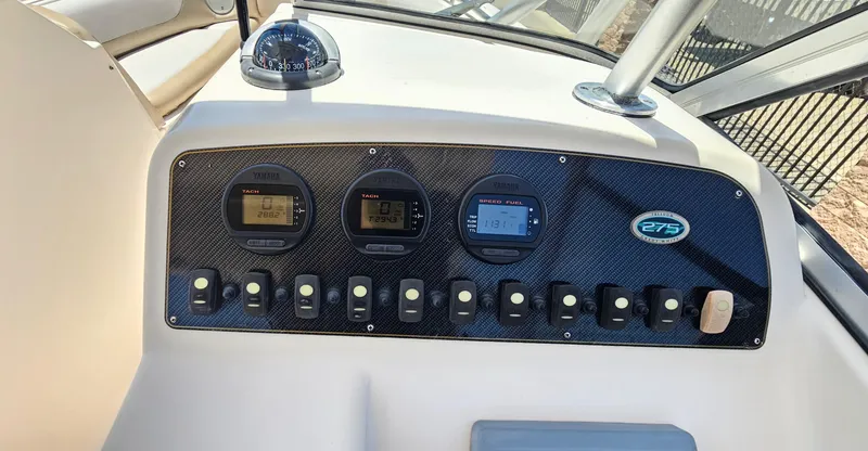Slide: The Image of Control panel of 2011 Grady-White Freedom 275 boat with gauges and switches. - 16