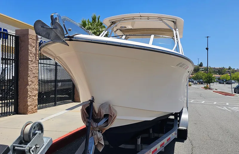 Slide: The Image of 2011 Grady-White Freedom 275 boat on trailer in parking lot. - 2