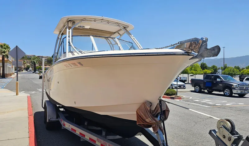 Slide: The Image of 2011 Grady-White Freedom 275 boat on trailer in parking lot. - 6