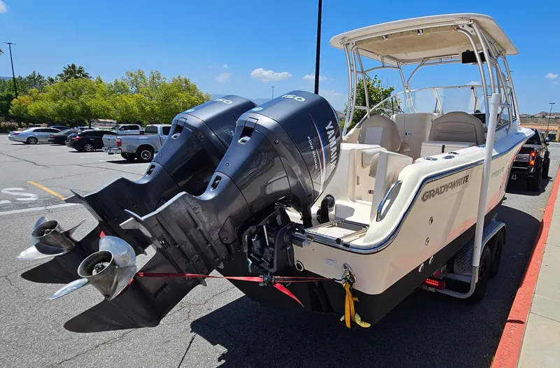 Slide: The Image of 2011 Grady-White Freedom 275 boat with dual Yamaha engines in a parking lot. - 7