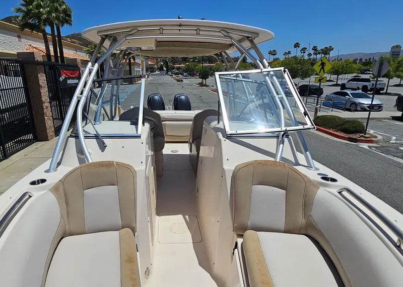 Slide: The Image of 2011 Grady-White Freedom 275 boat in a parking lot, showcasing seating and windshield. - 8