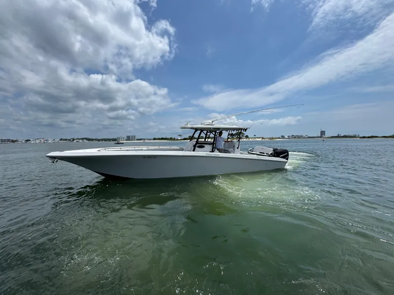 Slide: The Image of 2021 Fountain 38TE boat cruising on a sunny day with cloudy skies. - 1