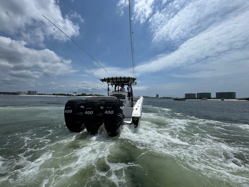 Slide: The Image of 2021 Fountain 38TE boat with triple 400 engines cruising on open water. - 10