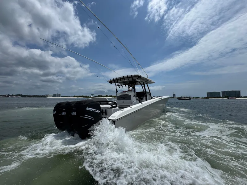 Slide: The Image of 2021 Fountain 38TE boat cruising on water with three Mercury engines. - 11