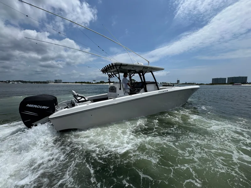 Slide: The Image of 2021 Fountain 38TE boat cruising on water with Mercury engine, under a partly cloudy sky. - 12