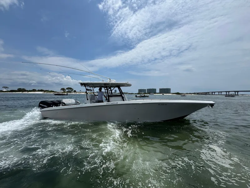 Slide: The Image of 2021 Fountain 38TE boat cruising on open water under a partly cloudy sky. - 14