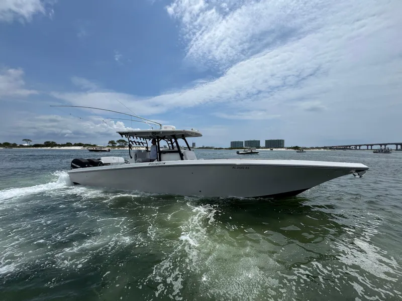 Slide: The Image of 2021 Fountain 38TE boat cruising on open water under a partly cloudy sky. - 15