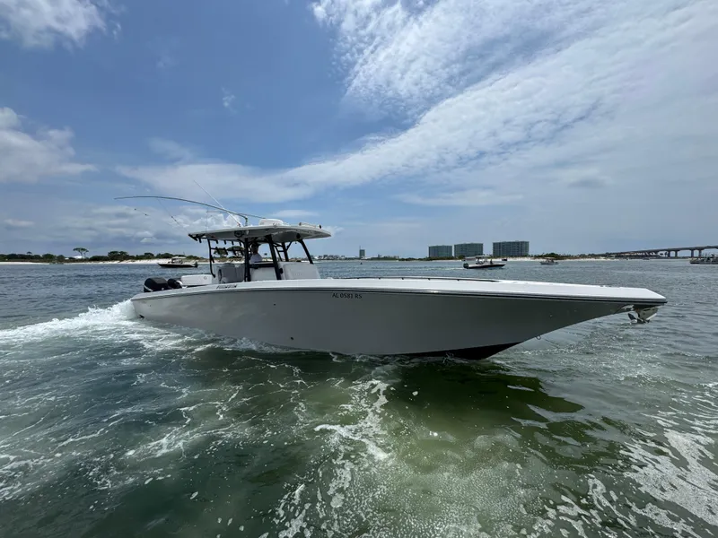 Slide: The Image of 2021 Fountain 38TE boat cruising on open water under a partly cloudy sky. - 16