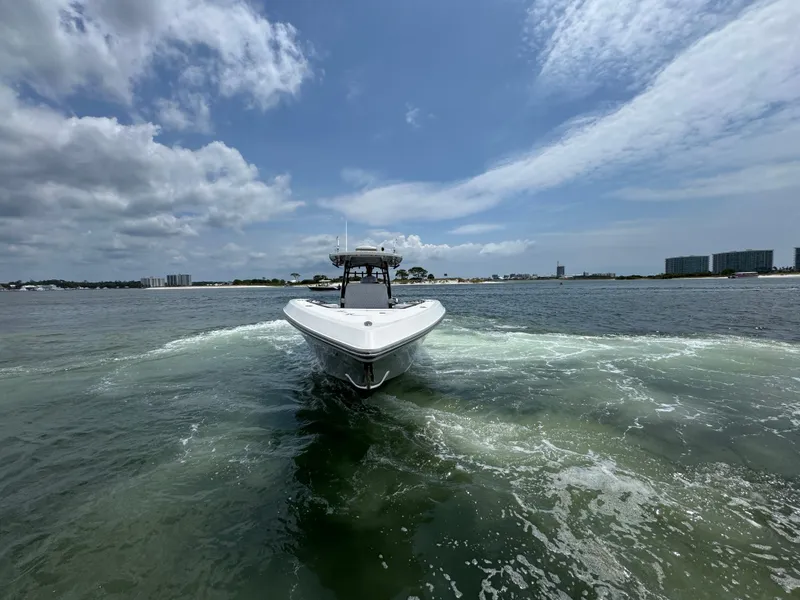 Slide: The Image of 2021 Fountain 38TE boat cruising on open water under a partly cloudy sky. - 19