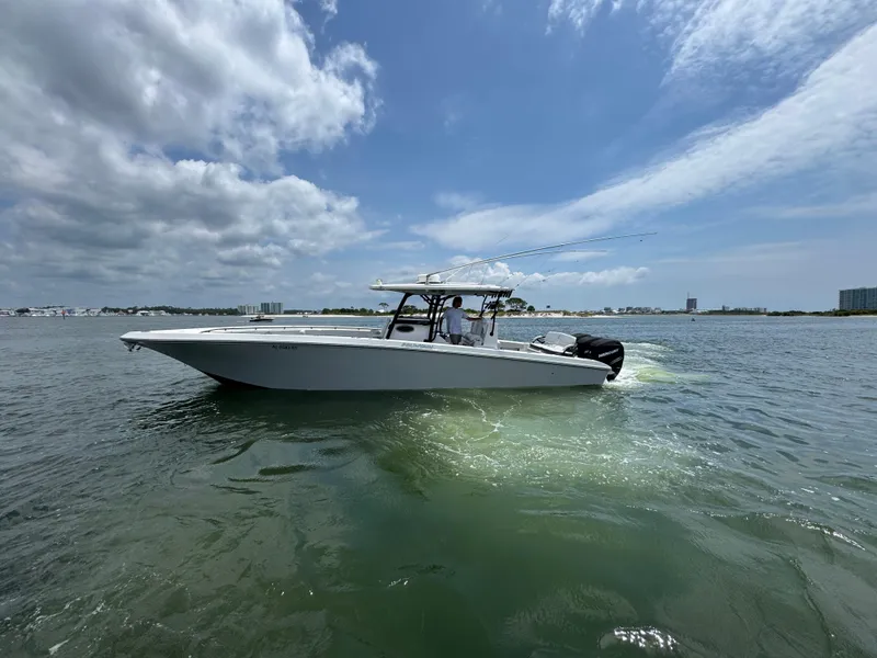 Slide: The Image of 2021 Fountain 38TE boat cruising on open water under a partly cloudy sky. - 2