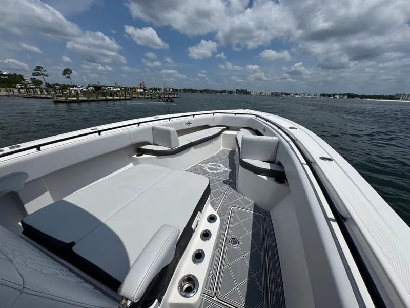 Slide: The Image of 2021 Fountain 38TE boat with spacious seating, docked on a sunny day. - 20