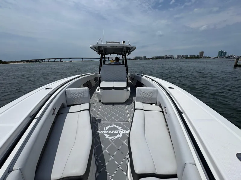 Slide: The Image of 2021 Fountain 38TE boat on water, featuring spacious seating and sleek design. - 25