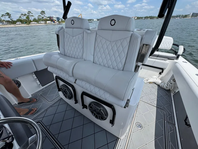 Slide: The Image of Luxury seating on a 2021 Fountain 38TE boat, featuring diamond-stitched upholstery and marine speakers. - 30