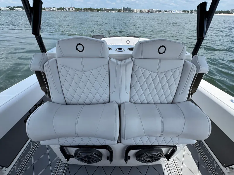 Slide: The Image of Luxury seating on a 2021 Fountain 38TE boat with quilted white upholstery. - 31