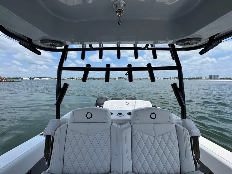 Slide: The Image of Fountain 38TE 2021 boat interior with seating, overlooking calm waters and distant shoreline. - 32