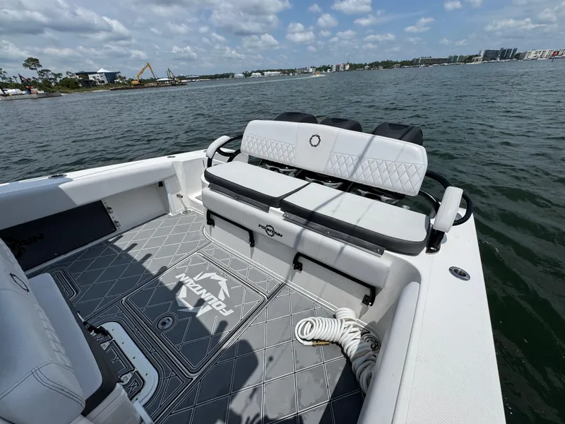 Slide: The Image of 2021 Fountain 38TE boat interior with seating and scenic water view. - 38