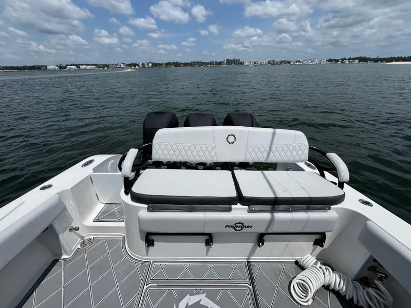 Slide: The Image of 2021 Fountain 38TE boat with seating, on a calm water body under a partly cloudy sky. - 39