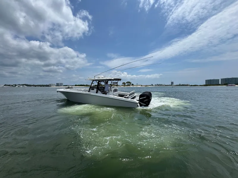 Slide: The Image of 2021 Fountain 38TE boat cruising on a sunny day with cityscape in background. - 4