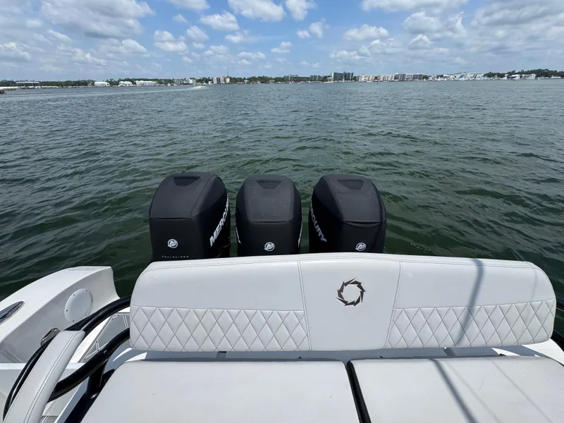 Slide: The Image of 2021 Fountain 38TE boat with triple Mercury engines on a calm water backdrop. - 40