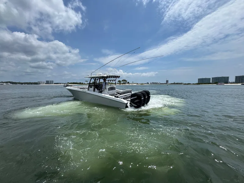 Slide: The Image of 2021 Fountain 38TE boat cruising on open water under a partly cloudy sky. - 5