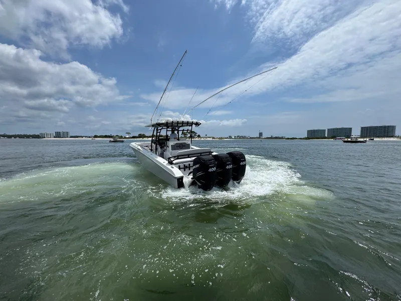 Slide: The Image of 2021 Fountain 38TE boat cruising on open water under a partly cloudy sky. - 6