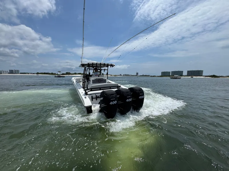 Slide: The Image of Fountain 38TE boat cruising on water, featuring triple 400 horsepower engines, 2021 model. - 7