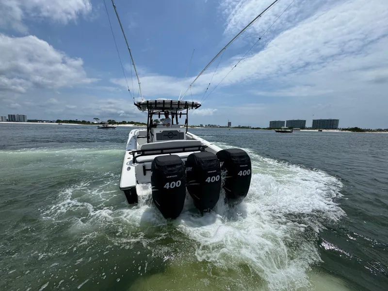 Slide: The Image of 2021 Fountain 38TE boat with triple 400 horsepower engines cruising on open water. - 8