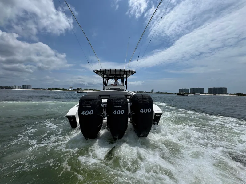 Slide: The Image of 2021 Fountain 38TE boat with triple 400 horsepower engines on open water. - 9