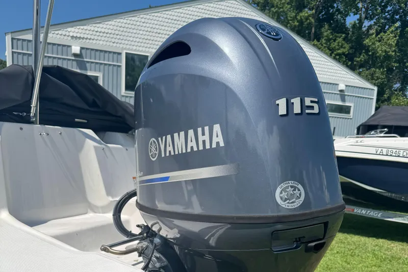 Slide: The Image of Yamaha 115 outboard motor on 2022 Hurricane SunDeck Sport 185 OB boat, outdoors. - 2