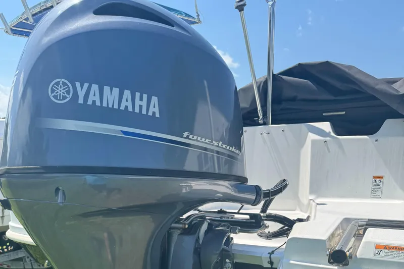 Slide: The Image of Yamaha four-stroke engine on 2022 Hurricane SunDeck Sport 185 OB boat, sunny day. - 3