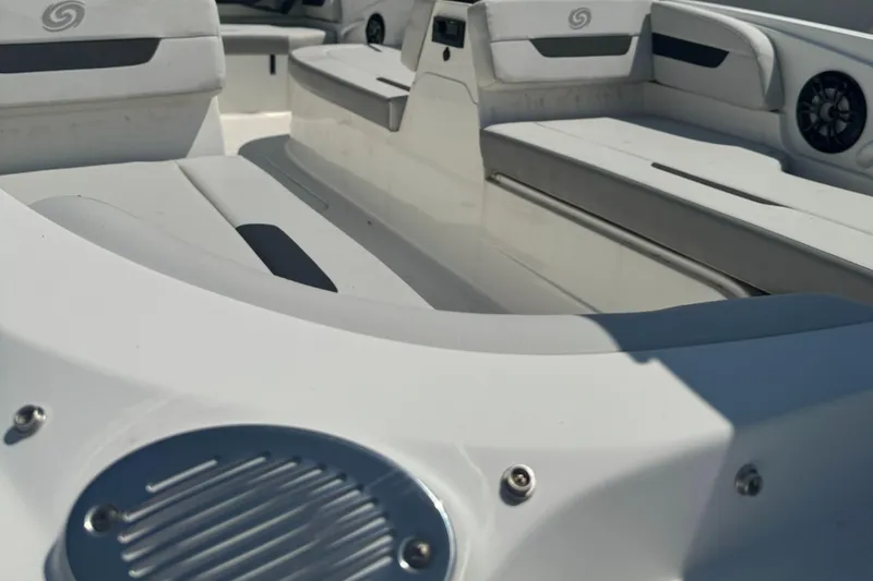 Slide: The Image of 2022 Hurricane SunDeck Sport 185 OB interior with white seating and speaker detail. - 4