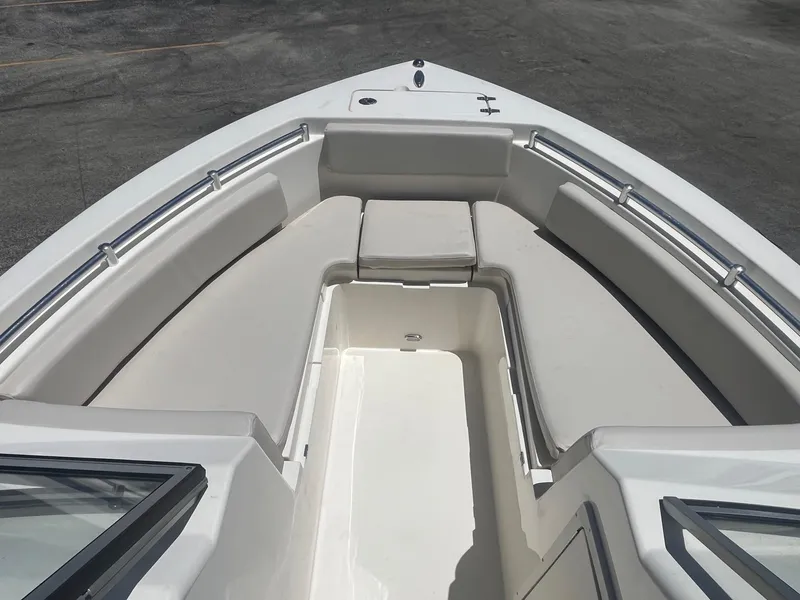 Slide: The Image of 2022 Cobia 220 Dual Console boat with spacious seating and sleek design. - 8
