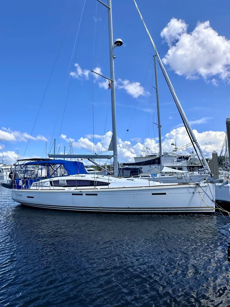 The Image of 2014 Jeanneau Sun Odyssey 44 DS sailboat docked under a clear blue sky. - 0