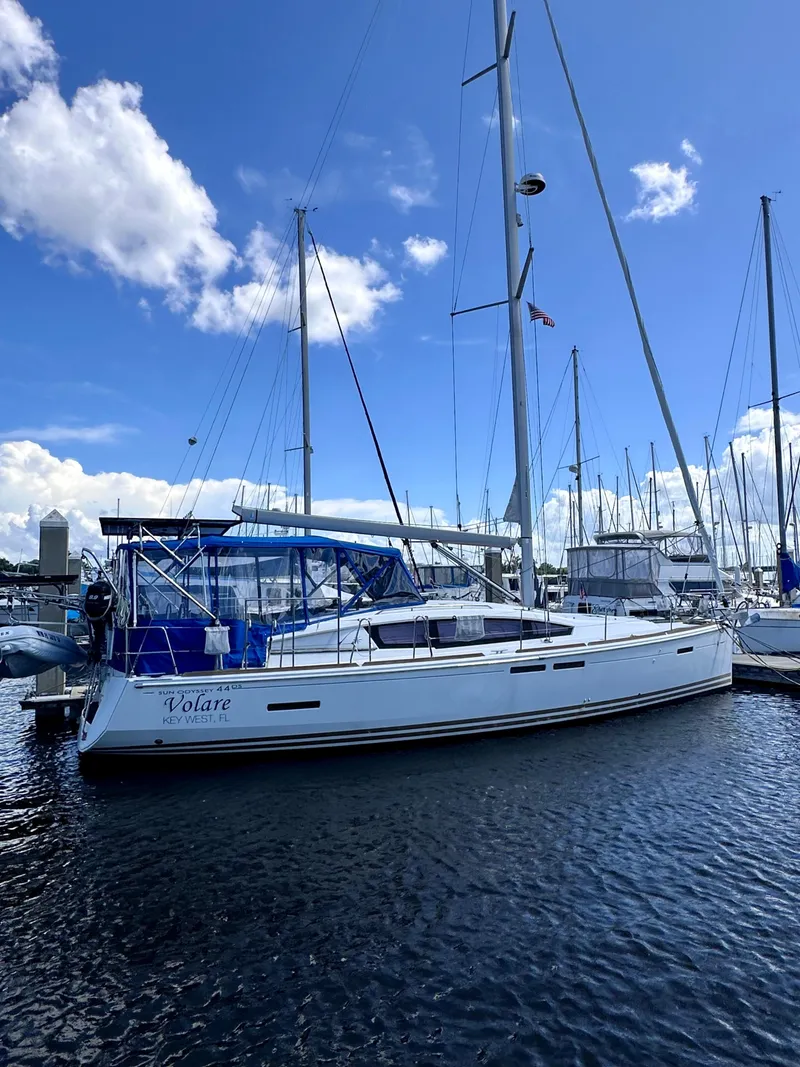 Slide: The Image of 2014 Jeanneau Sun Odyssey 44 DS sailboat docked in marina under blue sky. - 1