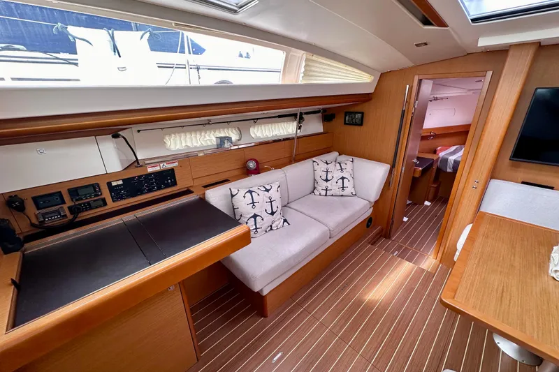 Slide: The Image of Interior of 2014 Jeanneau Sun Odyssey 44 DS yacht with modern furnishings and navigation equipment. - 10