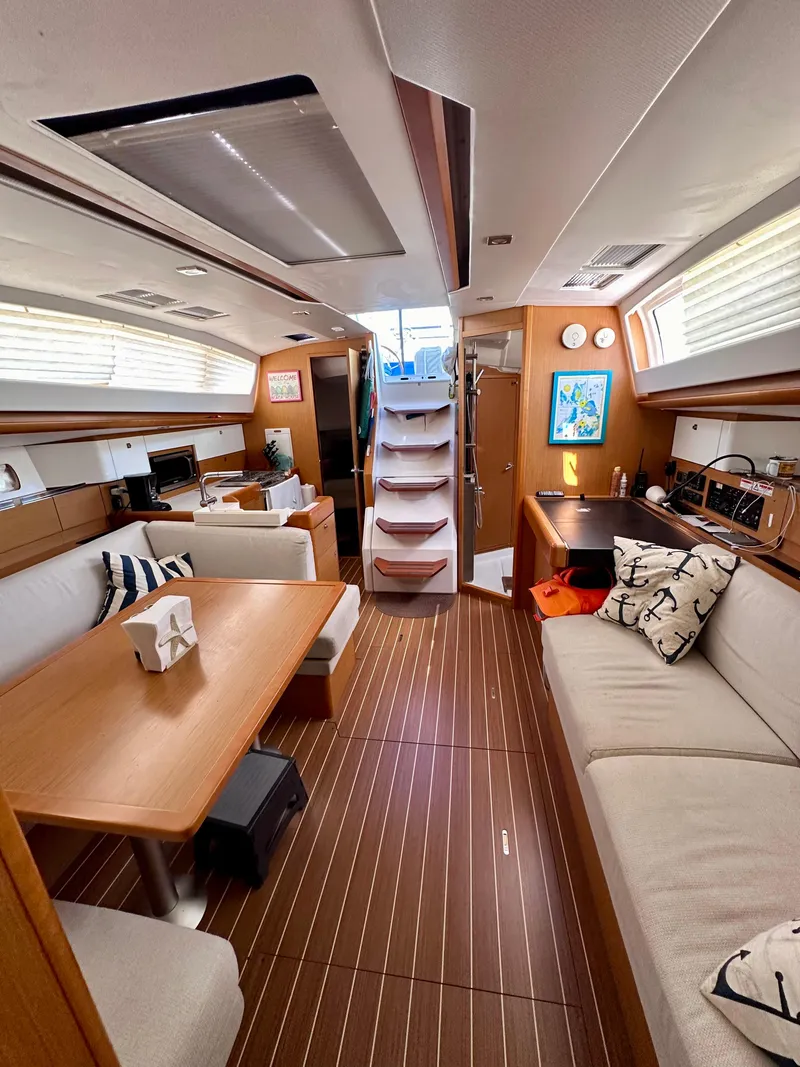 Slide: The Image of Interior of 2014 Jeanneau Sun Odyssey 44 DS yacht with modern furnishings and wood flooring. - 14