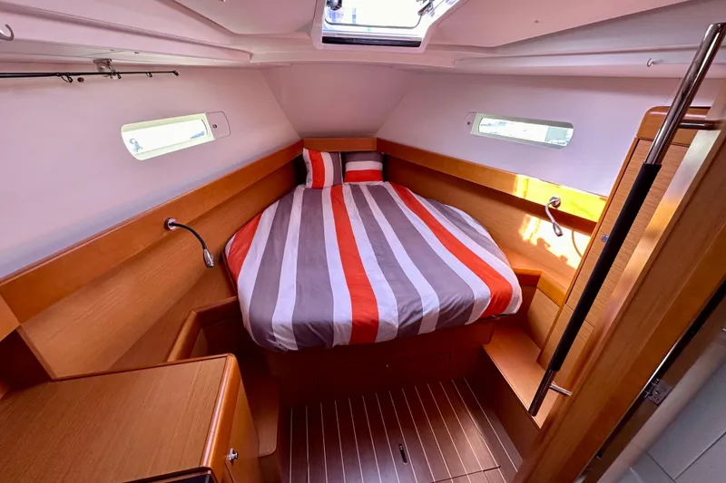 Slide: The Image of Cozy cabin interior of 2014 Jeanneau Sun Odyssey 44 DS with striped bedding. - 15