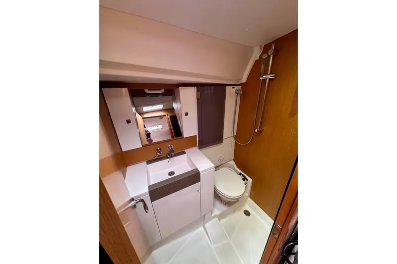 Slide: The Image of Bathroom interior of 2014 Jeanneau Sun Odyssey 44 DS yacht, featuring sink, toilet, and shower. - 17