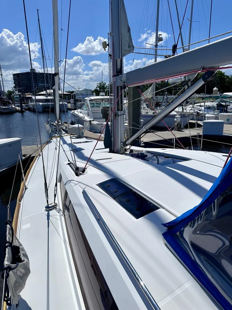 Slide: The Image of 2014 Jeanneau Sun Odyssey 44 DS sailboat docked at marina under blue sky. - 5