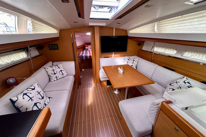 Slide: The Image of Luxurious interior of 2014 Jeanneau Sun Odyssey 44 DS yacht with cozy seating and elegant decor. - 8
