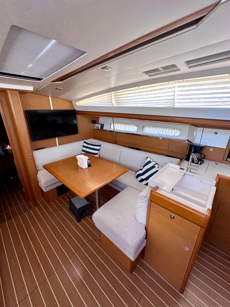Slide: The Image of Interior of 2014 Jeanneau Sun Odyssey 44 DS yacht with cozy seating and modern amenities. - 9