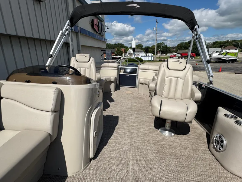Slide: The Image of 2019 Bennington SX 21 SSRCX pontoon boat interior with beige seating and canopy. - 12