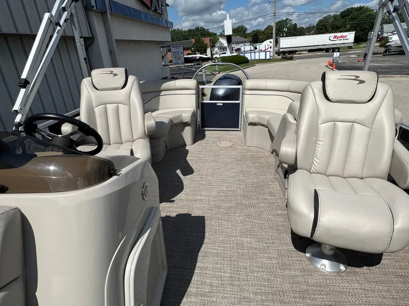 Slide: The Image of 2019 Bennington SX 21 SSRCX pontoon boat interior with plush seating and steering console. - 13